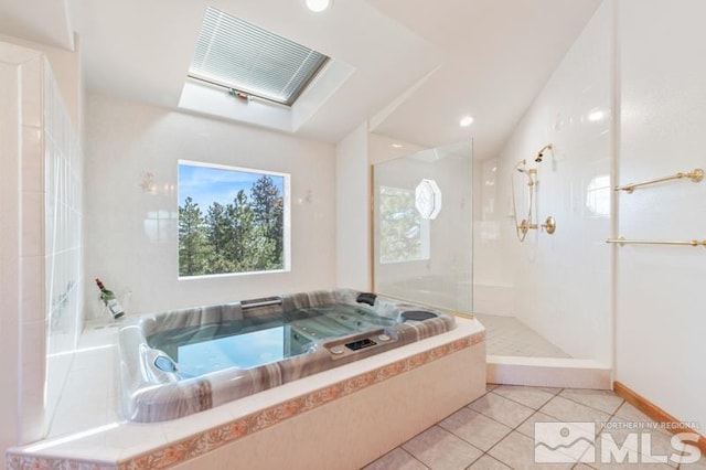 bathroom featuring independent shower and bath and tile flooring