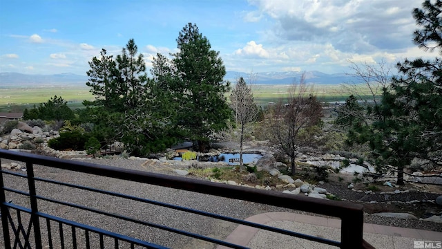 balcony featuring a rural view and a mountain view