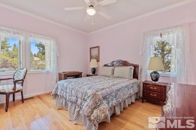 bedroom featuring ceiling fan, light wood-type flooring, and ornamental molding