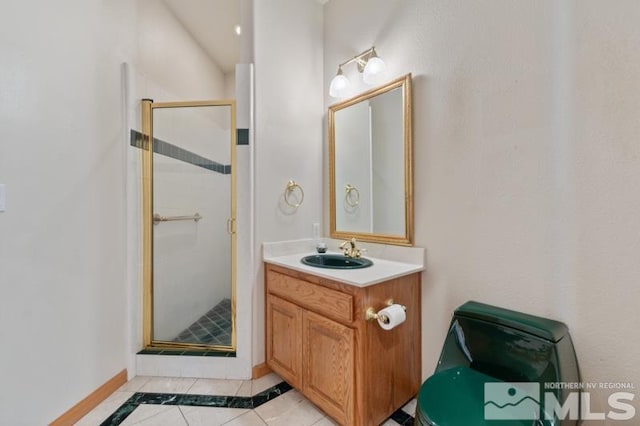 bathroom featuring a shower with door, oversized vanity, and tile flooring