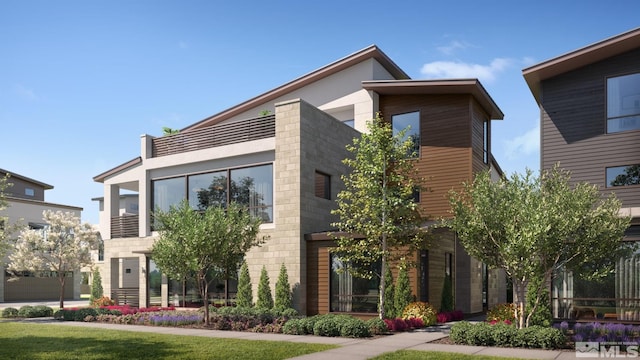 view of front of property featuring a garage and a front lawn