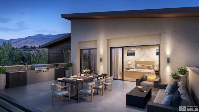 view of patio / terrace with an outdoor hangout area, a mountain view, an outdoor kitchen, and area for grilling