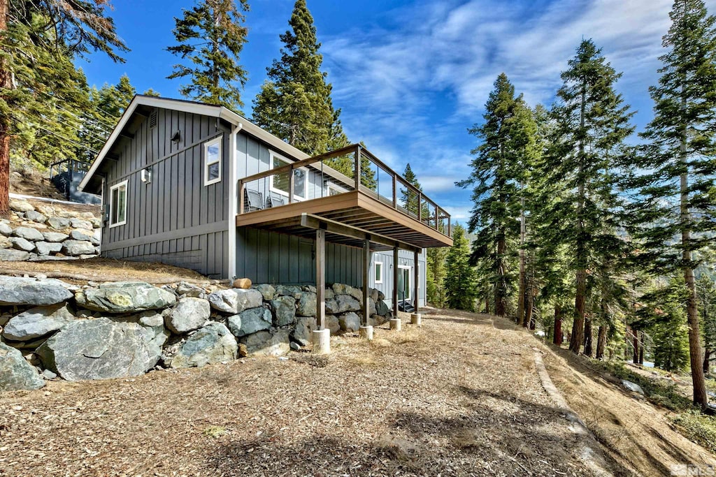 rear view of house featuring a deck