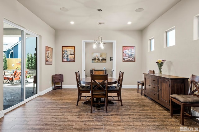 dining area featuring a notable chandelier and dark hardwood / wood-style floors