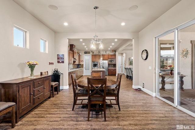 dining area with a notable chandelier and hardwood / wood-style floors