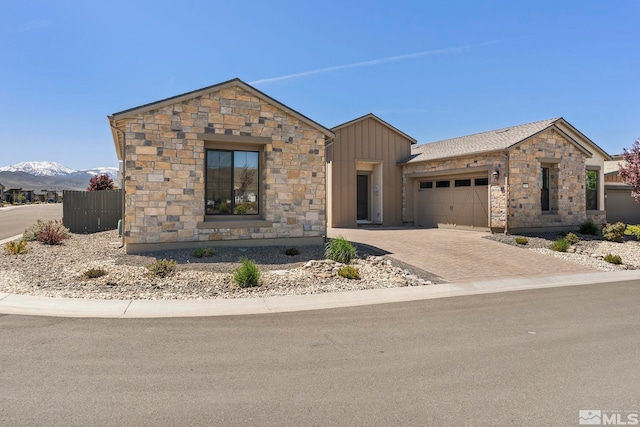 view of front of property featuring a garage and a mountain view