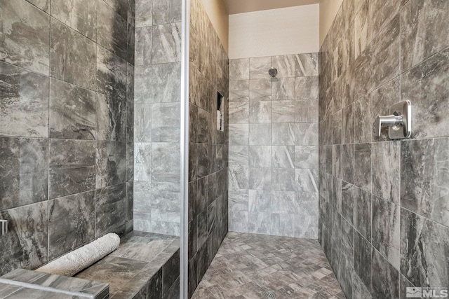 bathroom with a tile shower