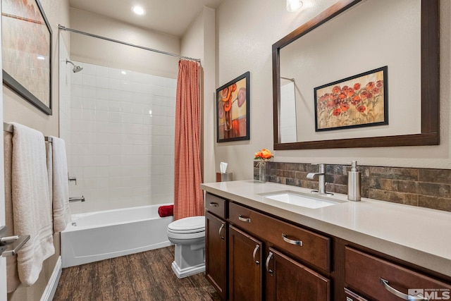 full bathroom with toilet, hardwood / wood-style floors, shower / tub combo with curtain, and vanity