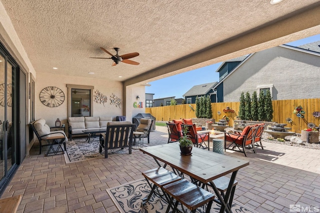 view of patio with outdoor lounge area and ceiling fan