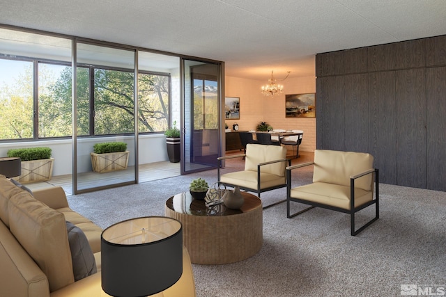 living room featuring wood walls, a chandelier, carpet floors, and a textured ceiling