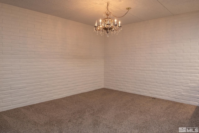 carpeted empty room with a chandelier