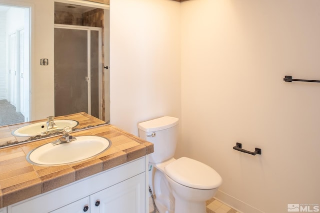 bathroom with vanity, tile floors, and toilet