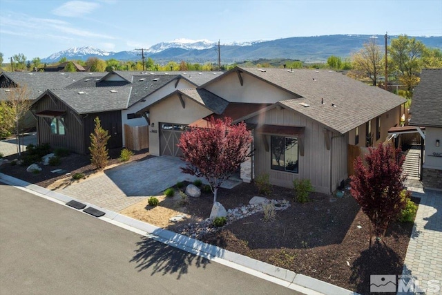 single story home with a mountain view and a garage