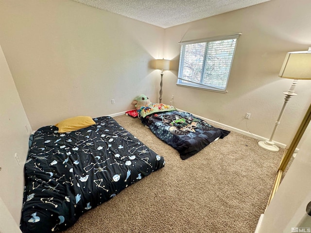 bedroom with a textured ceiling and carpet