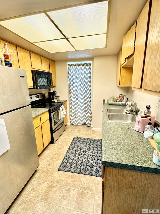 kitchen featuring light tile flooring, stainless steel electric range, sink, and fridge