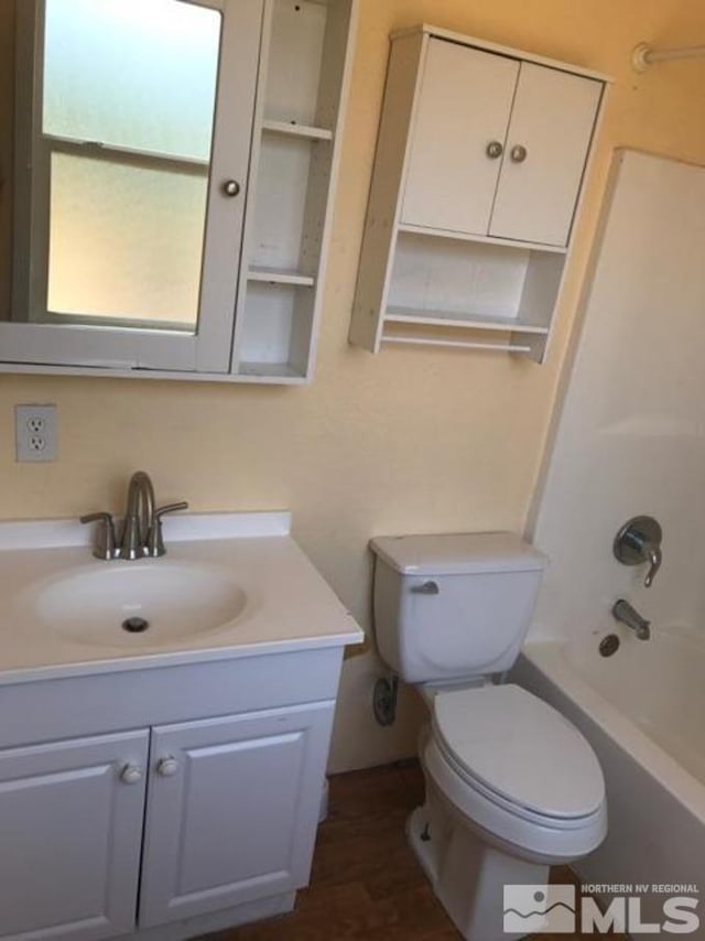 full bathroom featuring vanity with extensive cabinet space, tub / shower combination, and toilet