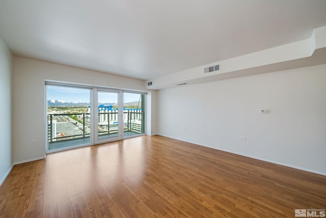 unfurnished room with wood-type flooring