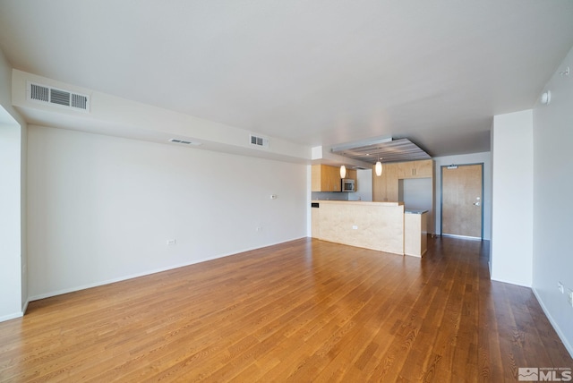 unfurnished living room featuring hardwood / wood-style flooring