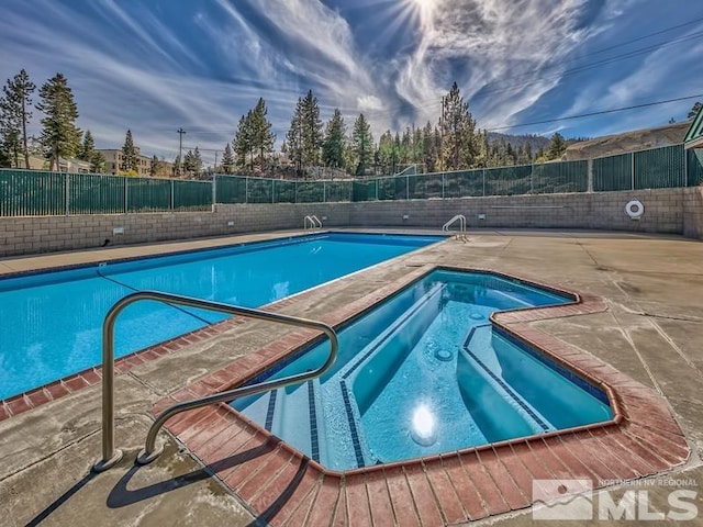 view of swimming pool with a patio area