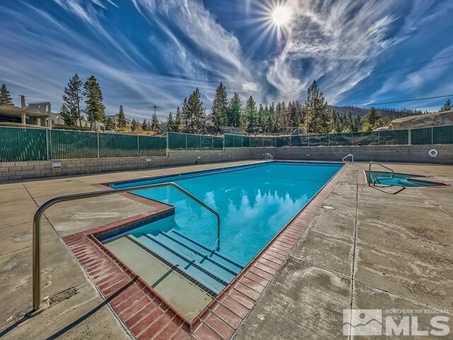 view of swimming pool with a patio