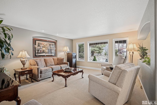 carpeted living room featuring a textured ceiling