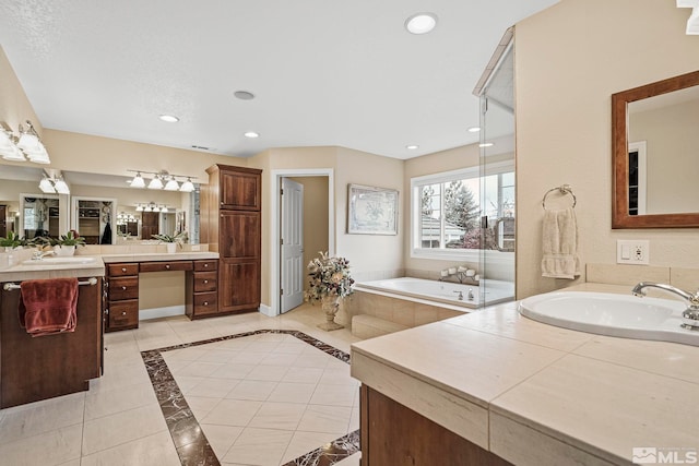 bathroom with tile floors, vanity with extensive cabinet space, and a bathtub