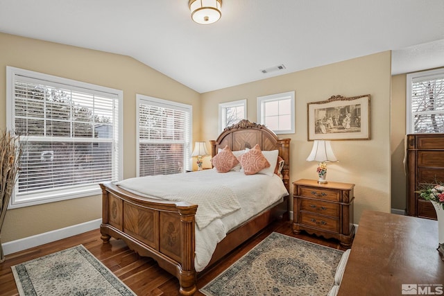 bedroom with vaulted ceiling and dark wood-type flooring