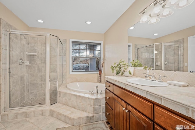 bathroom with large vanity, tile floors, and shower with separate bathtub