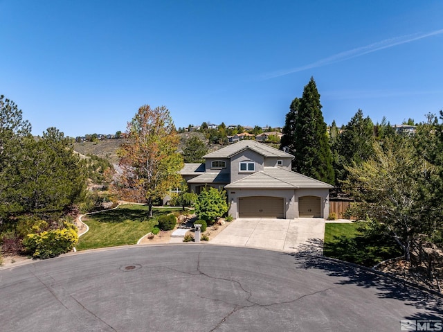 view of front of home featuring a garage and a front lawn