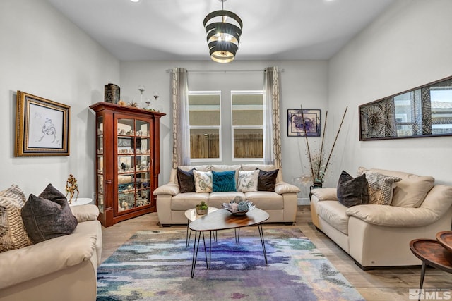 living room featuring wood-type flooring and a chandelier