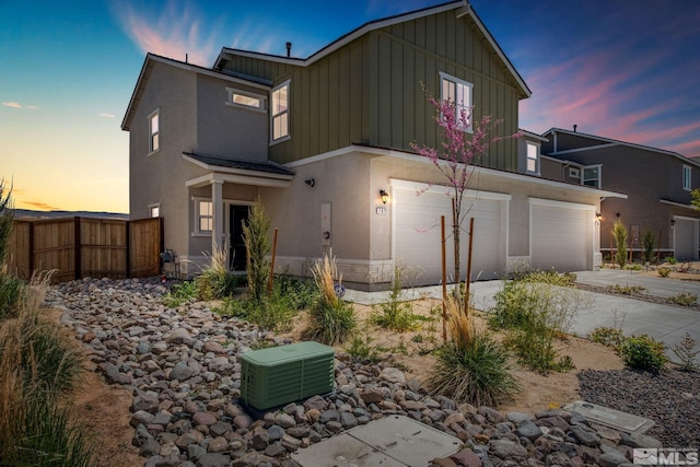 back house at dusk with a garage