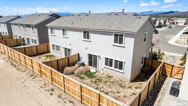back of house with central AC and a mountain view
