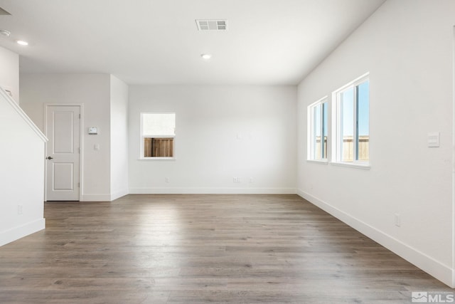 spare room with hardwood / wood-style floors