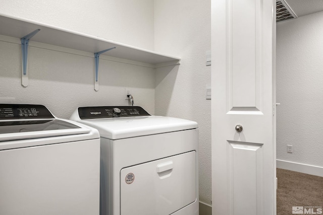 laundry room with independent washer and dryer and carpet