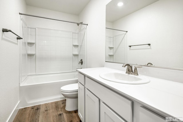 full bathroom featuring hardwood / wood-style floors, vanity, bathtub / shower combination, and toilet