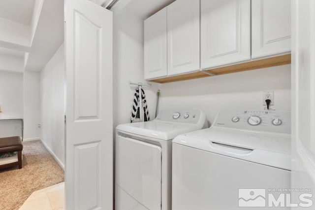 laundry area featuring independent washer and dryer, cabinets, and light tile floors