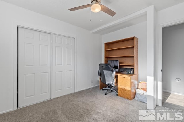 carpeted office with ceiling fan