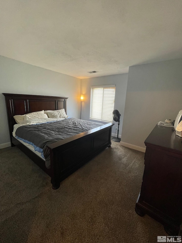 bedroom with dark carpet