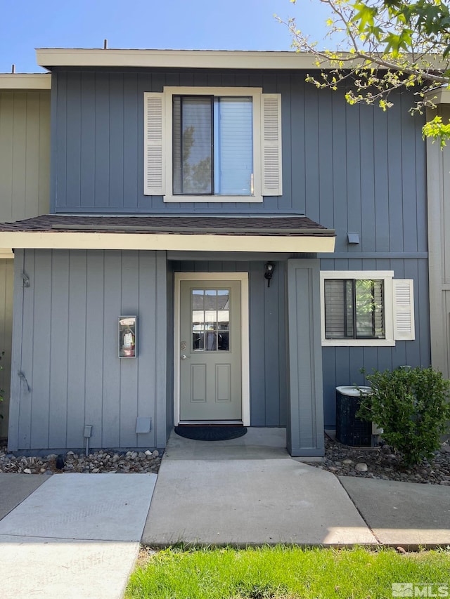 property entrance featuring central AC unit