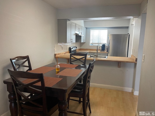 dining space featuring light hardwood / wood-style floors and sink