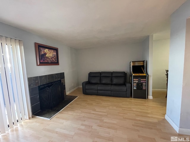 living room featuring light hardwood / wood-style floors and a fireplace