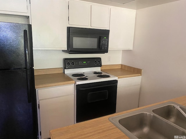 kitchen featuring white cabinetry, black appliances, and sink