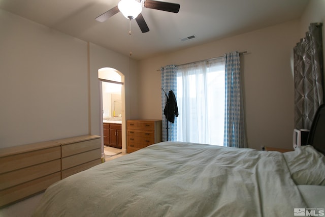 bedroom with ceiling fan and ensuite bath