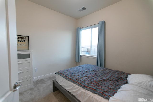 bedroom featuring light colored carpet