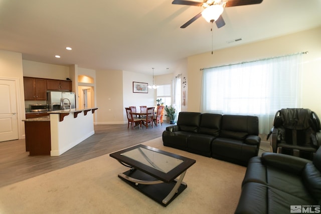 living room featuring ceiling fan and dark wood-type flooring