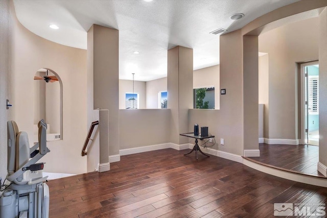 workout room with a textured ceiling and dark hardwood / wood-style floors