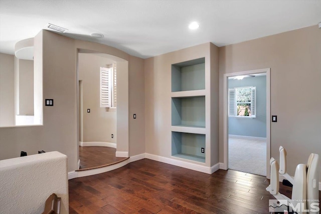 entrance foyer featuring dark colored carpet