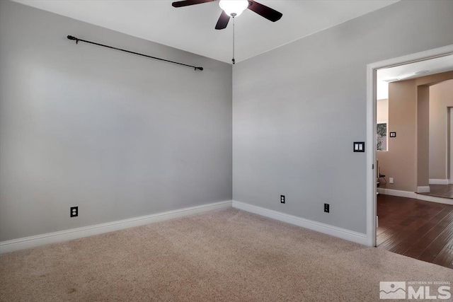 unfurnished room with ceiling fan and dark hardwood / wood-style flooring