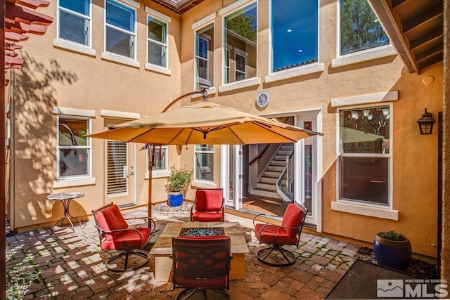 view of terrace featuring an outdoor fire pit