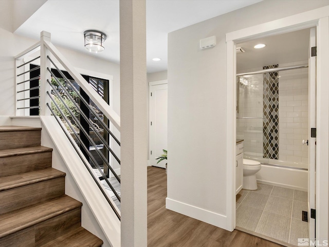 staircase featuring wood-type flooring